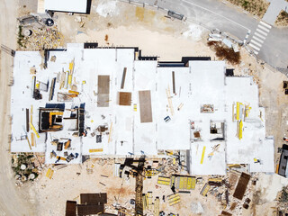 Aerial drone view of workers on construction site. Apartment building under construction in city.    