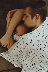 father fell asleep with the baby in his arms