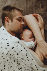 father fell asleep with the baby in his arms