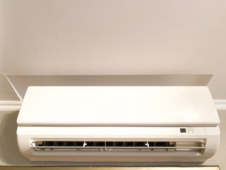 White wall-mounted air conditioner in a house or apartment close-up