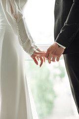 bride and groom holding hands together