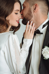 couple kissing in studio close up portrait of bride and groom