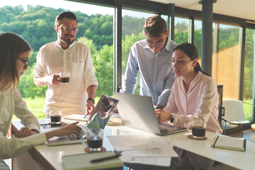 Successful programmers studying at IT camp in a country cottage at mountains