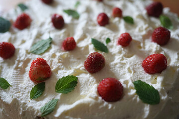 Beautiful strawberry cream cake with peppermint leaves    