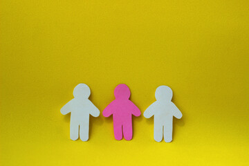 Paper cut pink human between two white paper people shapes. Three figures. Social interaction concept. Team work. Diversity. - obrazy, fototapety, plakaty