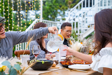 Group of diversity Asian millennial people friends enjoy outdoor garden dinner party eating food...