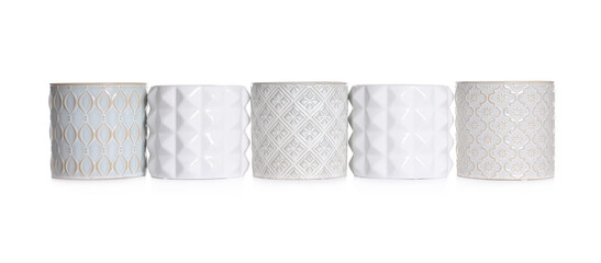 Different stylish ceramic flowerpots on white background