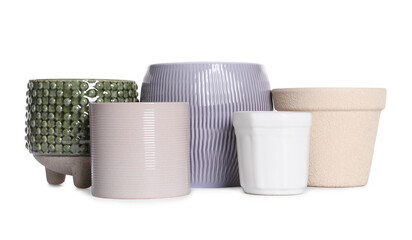 Different stylish ceramic flowerpots on white background