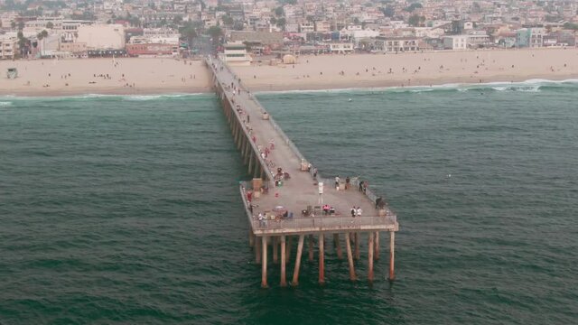 Aerial: Hermosa Beach Pier and tourists. Los Angeles, USA