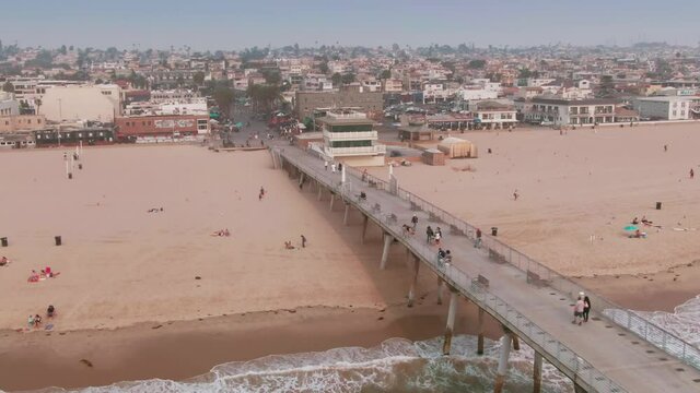 Aerial: Hermosa Beach Pier and tourists. Los Angeles, USA