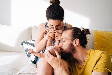 Fototapeta premium young family spending time with new born baby in modern living room