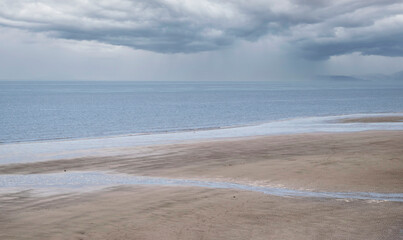 Fototapeta na wymiar Skegness beach landscape with a stormy sky.