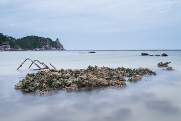 Old broken steps in the sea with long exposure and copy space