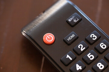 Closed up on remote control keypad and put on the wood table