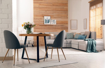 Spacious apartment interior with table and comfortable sofa