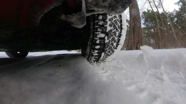 Car Front Tyre and Suspension System When Driving on Snowy Road Wide Angle POV