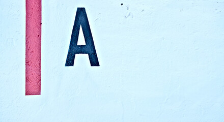 Capital letter A and a short vertical red line on a white background.