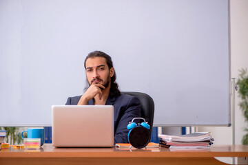 Young male teacher in the classroom