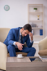 Young male employee waiting for business meeting