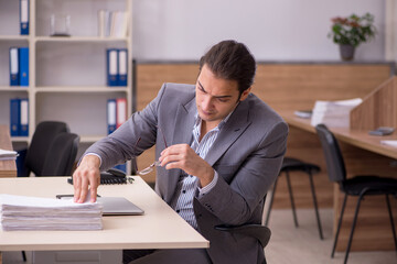 Young male employee working in the office