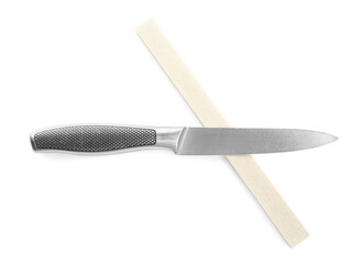 Sharpening stone and knife on white background, top view