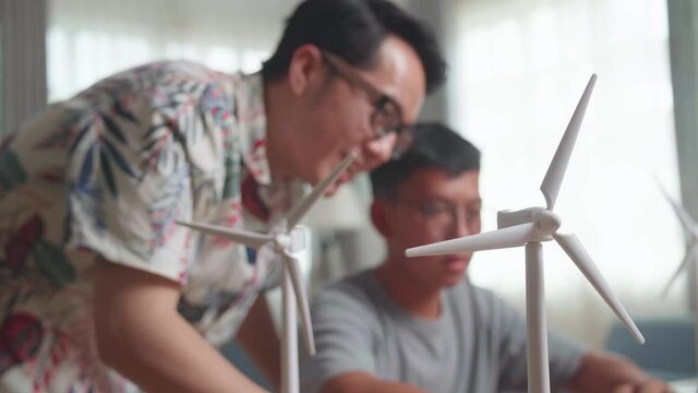 Blur Happy Teacher And Student Use Laptop Computer Programming Electric Wind Turbine
