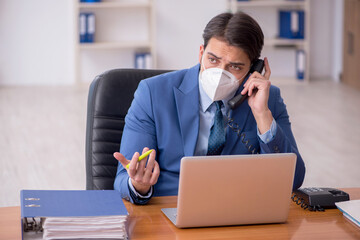 Young businessman employee working in the office during pandemic