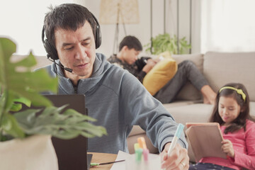 Father working from home with children. Homeschooling, stay home, social distancing during covid...