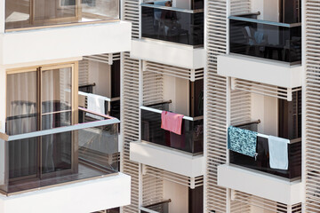 Balconies of the hotel rooms. Glass balconies, on which towels hang.