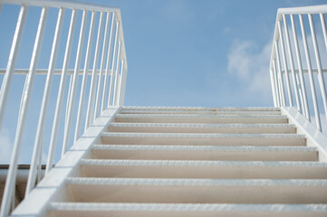 Fototapeta premium Stairs extending to the sky with thin clouds