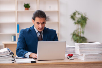 Young male employee unhappy with excessive work