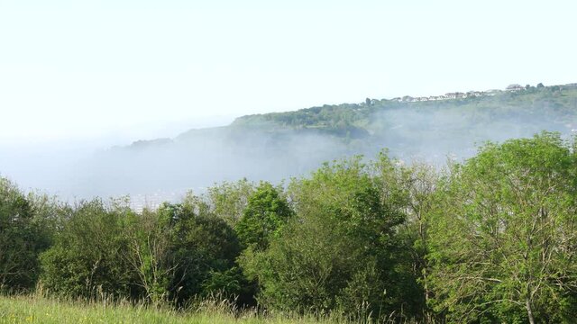 Time lapse of fog rolling in through a valley in summer in England
