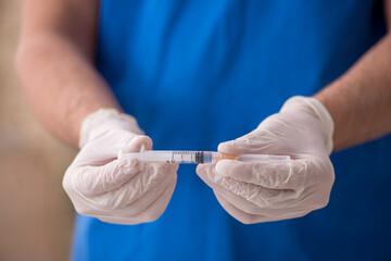 Young male doctor in vaccination concept during pandemic