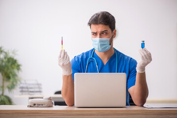 Young male doctor in vaccination concept during pandemic