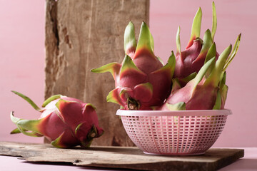 Ripe organic dragon fruit on pink background, tropical fruit mostly in Southeast Asia, refreshing and healthy eating sweet taste