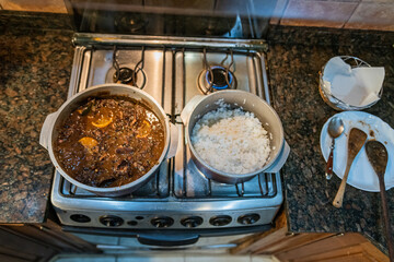 Cooking typical Brazilian dish called Feijoada. Made with black beans, pork and sausage.