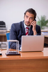 Young man businessman employee sitting in the office