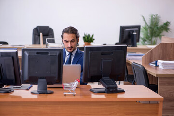 Young male employee in ecommerce concept