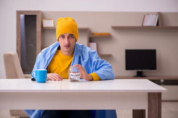 Young man suffering at home in expensive medicine concept