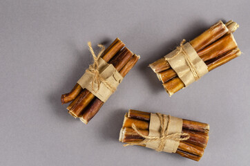 Bully sticks for dogs wrapped in brown paper and tied with twine
