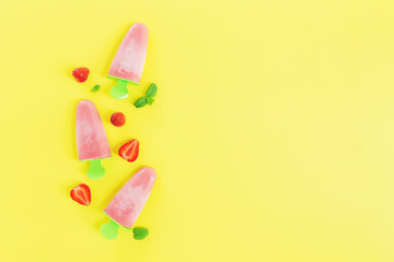 Fruity frozen sorbet ice-cream with strawberry, mint on yellow background