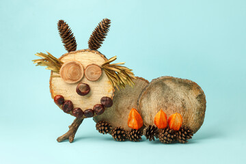 Seasonal autumn craft with kids. Children's cute worm or caterpillar made of natural materials -...