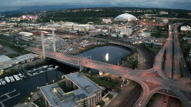 Cinematic 4K sunset evening aerial drone shot of the Moon's reflection in Thea Foss Waterway, Tacoma downtown waterfront, Tacoma dome, Dock Street Marina, yachts and sailboats in Tacoma, Washington