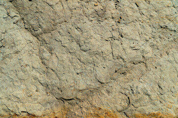 Close-up of uneven surface of a gray rock. Material for construction