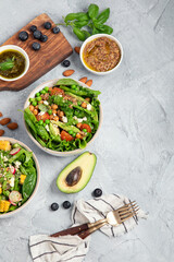 Fototapeta na wymiar Assorted vegan salads on dark gray background. Seasonal food concept.