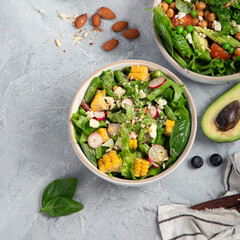 Assorted vegan salads on dark gray background. Seasonal food concept.