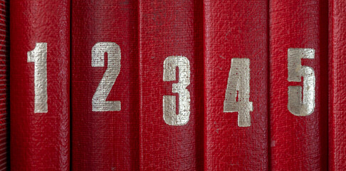 Lomos rojos de enciclopedias con números dorados