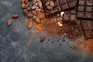 Cacao beans and chocolate on gray background. © bit24