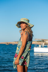 Latin model whit hat smiling with sea background