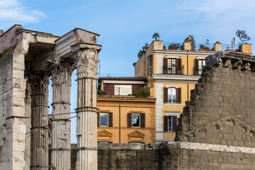 Fototapeta na wymiar Remains of the Temple of Mars Ultor in the Forum of Augustus with a modern building at background in Rome, Italy